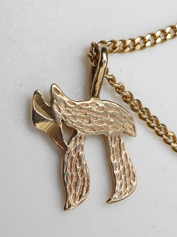 A gold necklace and pair of earrings